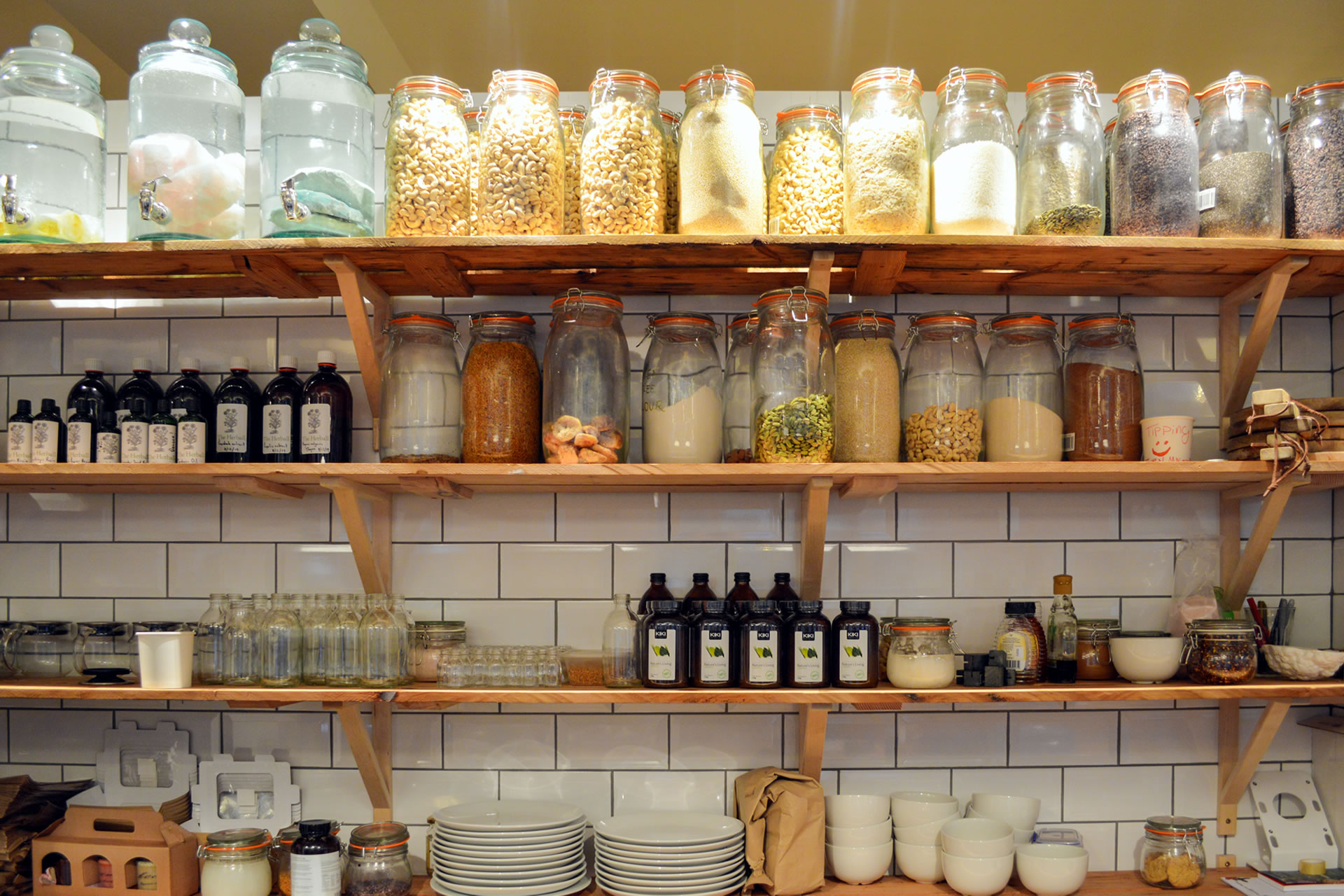 Beautifully organized pantry with open shelving and glass jars